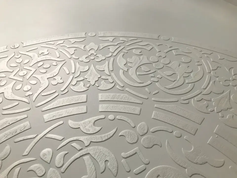 Detail reliéfního ornamentu mandaly na stěrkové podlaze