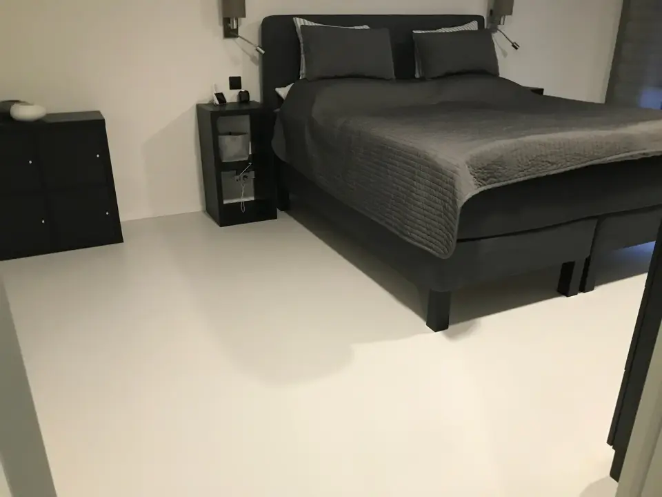 Ložnice s bílou bezespárou podlahou ze stěrky