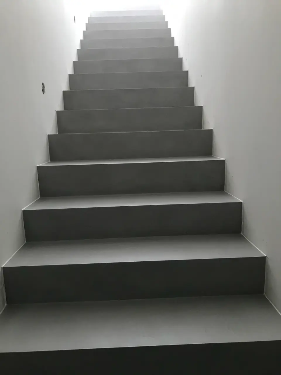 Dlouhé rameno schodiště v šedé stěrce